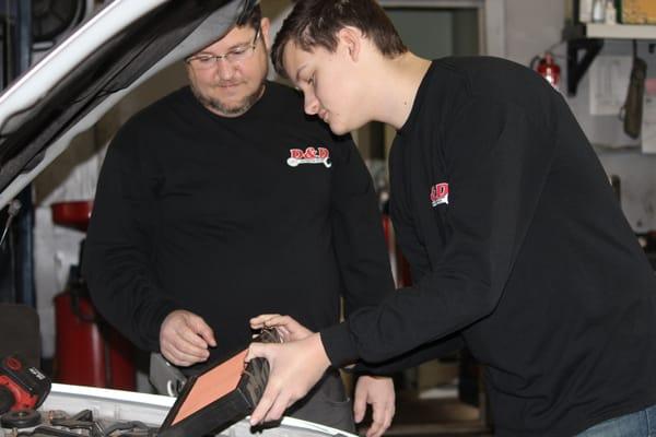 Doug teaching Dylan how to check an air filter.