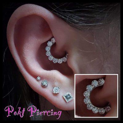 Daith piercing with jewelry from Industrial Strength implant grade titanium with CZ clear/gem ends.