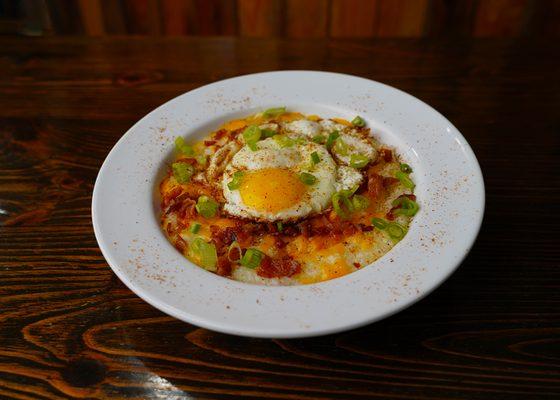 Cajun Grits!  grits with cheddar, bacon, fried egg, green onions, and Cajun seasoning.