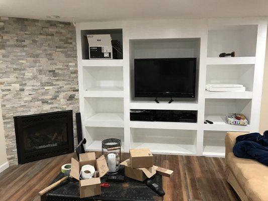 Custom built entertainment center and custom veneer fireplace