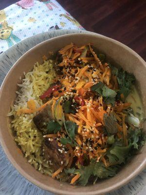 Curry chicken bowl with greens and basmati rice.