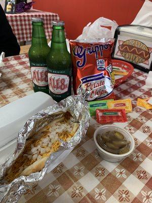 Hot dog with chili, cheese and onion. Jalapeños on the side, chips and Ale81.