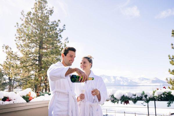 Couple enjoying champagne on their lakeside patio