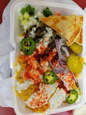 Falafel platter, added spinach, chickpeas, and lentils. Spicy with jalapeños and pickles. Delicious!