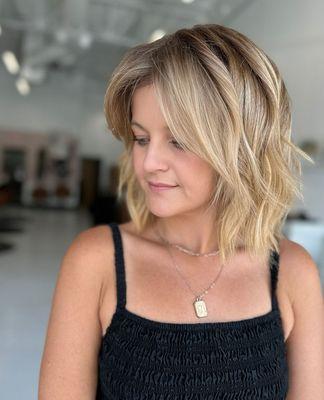 Fresh summer chop!  Embrace the season with a light, fun, and flirty look. Ready for your transformation? Book now!