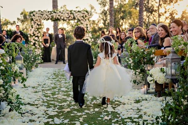 Very cute ring bearer and flower girl walking down the aisle. Park Hyatt Aviara Wedding.