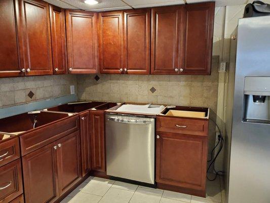 They installed the dishwasher and even put new outlets in to the left of the fridge.