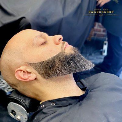 Head shave and beard trim with mild coloring  at Made Man Barbershop