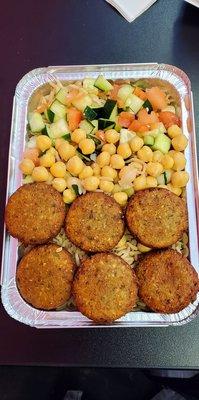 Falafel over rice with tomato and cucumber, and chick peas. Everything is always fresh and delicious at Shah's Halal.