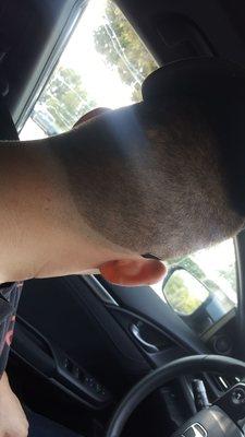 An inch above his hairline, and all the way up his ear.