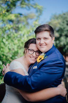 A closeup of me and my wife. I'm in the white dress, and I can't say enough about how much I love my hair and makeup by Samantha of Adore!