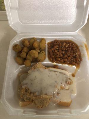 Chicken fried steak smothered with delicious creamy white gravy on toast, bbq baked beans and fried okra