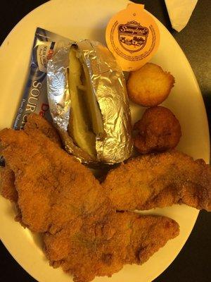 Four Piece hand-breaded catfish fillets,  baked potato with hush puppies and unlimited salad bar was only $11.50 (5/2017) A great value.