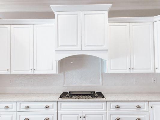 A kitchen with a elegant backsplash