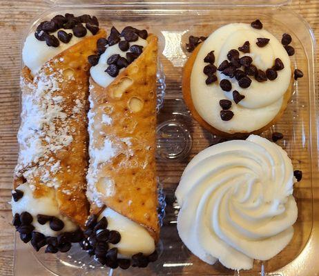 two cupcakes and two  cannolis.