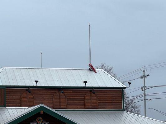 The US flag on top of Texas steak house. Left laying on the roof.