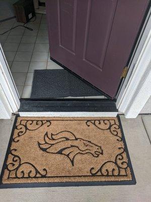 Denver Broncos entry mat at doorstop of our new home. The Broncos might be losing, but Gaelic Moving & Storage is winning.