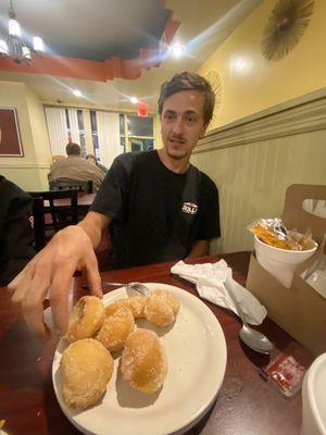 My friend chowing down on some tasty sugar rolls