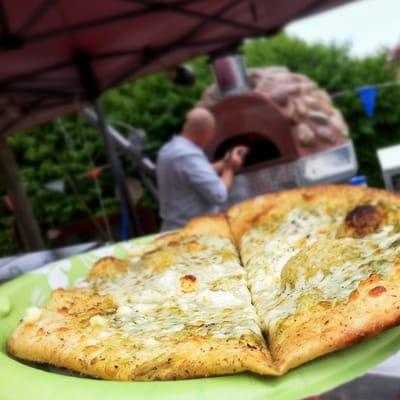 Basil Pesto Pizza with Mozzarella & Feta Cheese from their wood-fired Pizza oven.