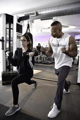 Properly Demonstrating A Lunge Curl With My Client.