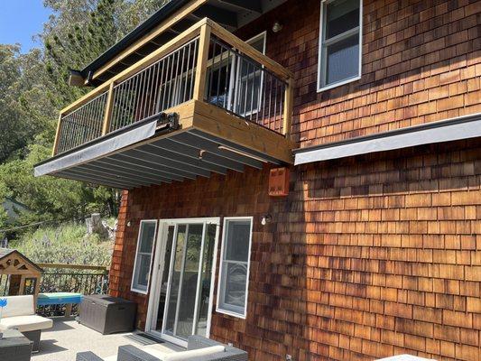 Cedar siding soft washed and stained. Balcony railing and fascia refinished.