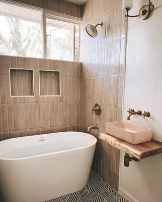 After  Custom sink, facet, linear drain, free standing tub, shower niche shelf built. New shower tiles and floor tiles installed.