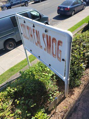 Front Entrance Sign, the Smog Check is behind the building.