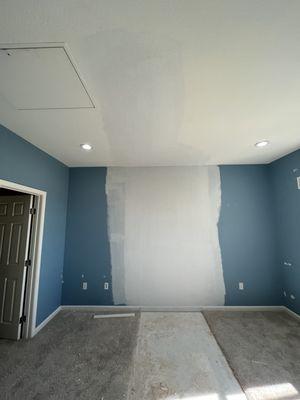 After: built-in bed, desks, and tv mounts removed. Wall and ceiling drywall repaired (including re-texture and molding).