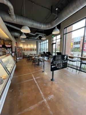 View of the dining room area and ordering station near the street entrance.