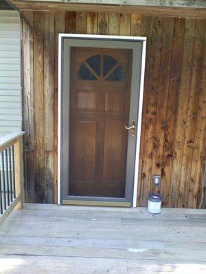 Custom Solid Wood Entry door to Custom built Locust Deck with Cedar railings and Metal Balusters, with electrical outlets