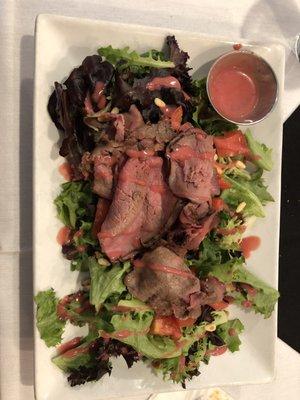 Tapenade Signature salad with shaved London Broil and house made raspberry vinaigrette