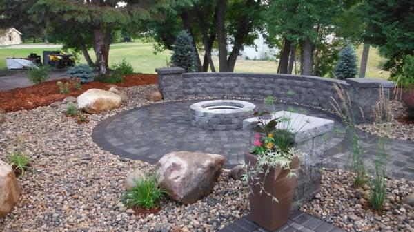 Custom fire pit and seating wall with intimate landscape setting.