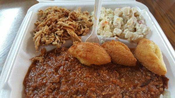 Pulled pork, hash over rice, potato salad, and 2 hush puppies.