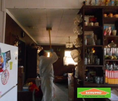 Smoke damage affects every surface in your house. Here crew chief Angel demonstrates one way we clean residue from ceilings.