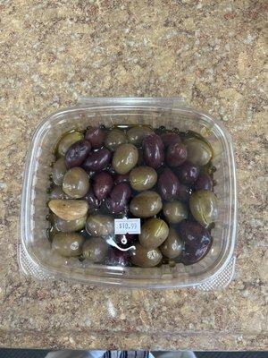 Home made olives with herbs in Olive Oil