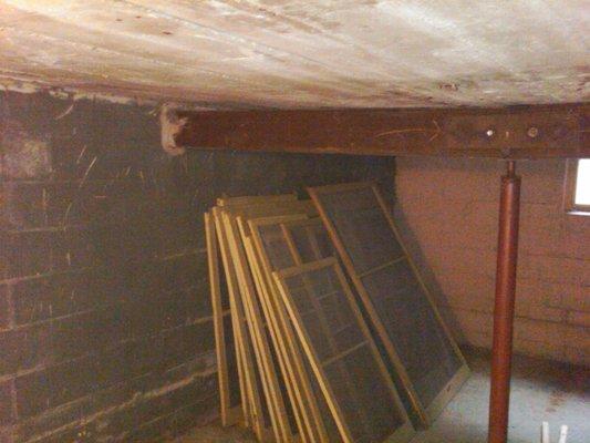 Storage room under a reinforced concrete garage slab.