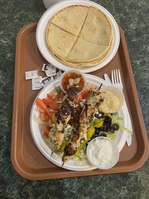 Chicken kebab with Greek salad, toasted, pita, fresh, tzatziki, hummus, and red pepper sauce