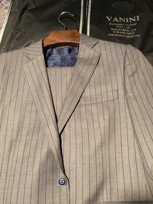 100% Italian wool, Grey suit with a dark blue pinstripe.