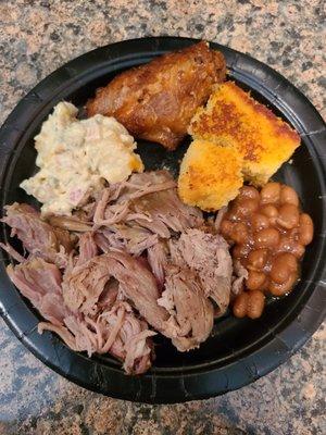 My sample plate from our to-go order: potato salad, wing, cornbread, baked beans and pork