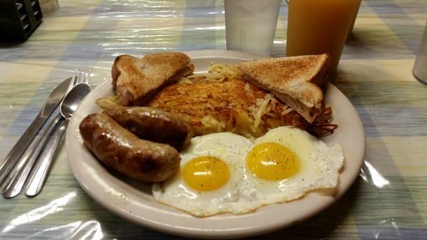 Eggs sunny side up, Gianelli sausage links, hash browns, and wheat toast