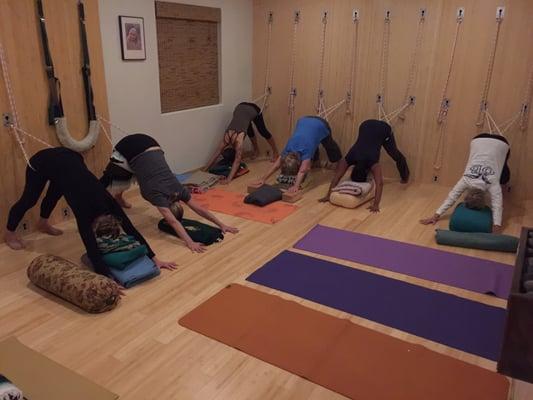 Adho Mukha Svanasana in ropes with head support - Ahhh restorative class