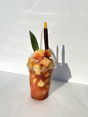 Empinada Loca (shaved ice topped w real pineapple pieces and pineapple syrup, lime, chamoy and tajin)