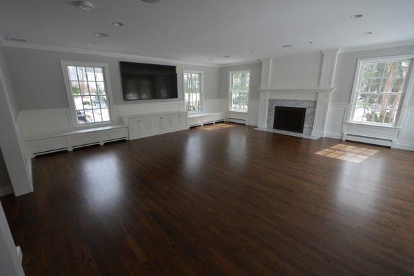 Whole home renovation in Wellesley with family room addition featuring fireplace, built-ins and window seats.