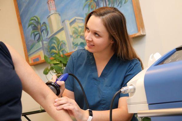 Our back office technician, Sophia, performing a Shockwave Treatment on a patient suffering from elbow pain.