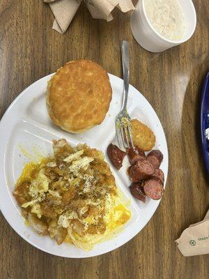 Two eggs over easy with potato cake and smoked sausage link.