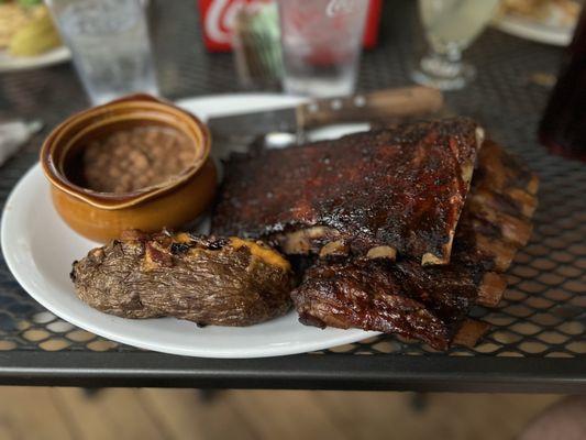 Ribs, beans, and baked potato.