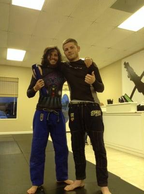 Derek Overby getting his blue belt from head jiu jitsu instructor, Sean Applegate.