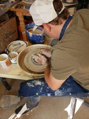 Students Learning How To "Throw" Pottery On The Wheel.