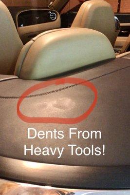 The heavy drill left dents in the convertible top cover!