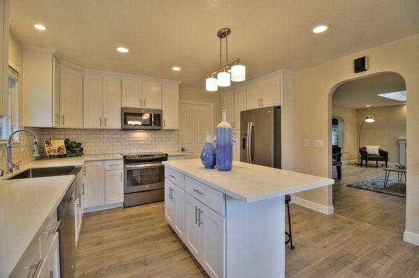 Another view of new white shaker kitchen and beautiful carrera white counter top.